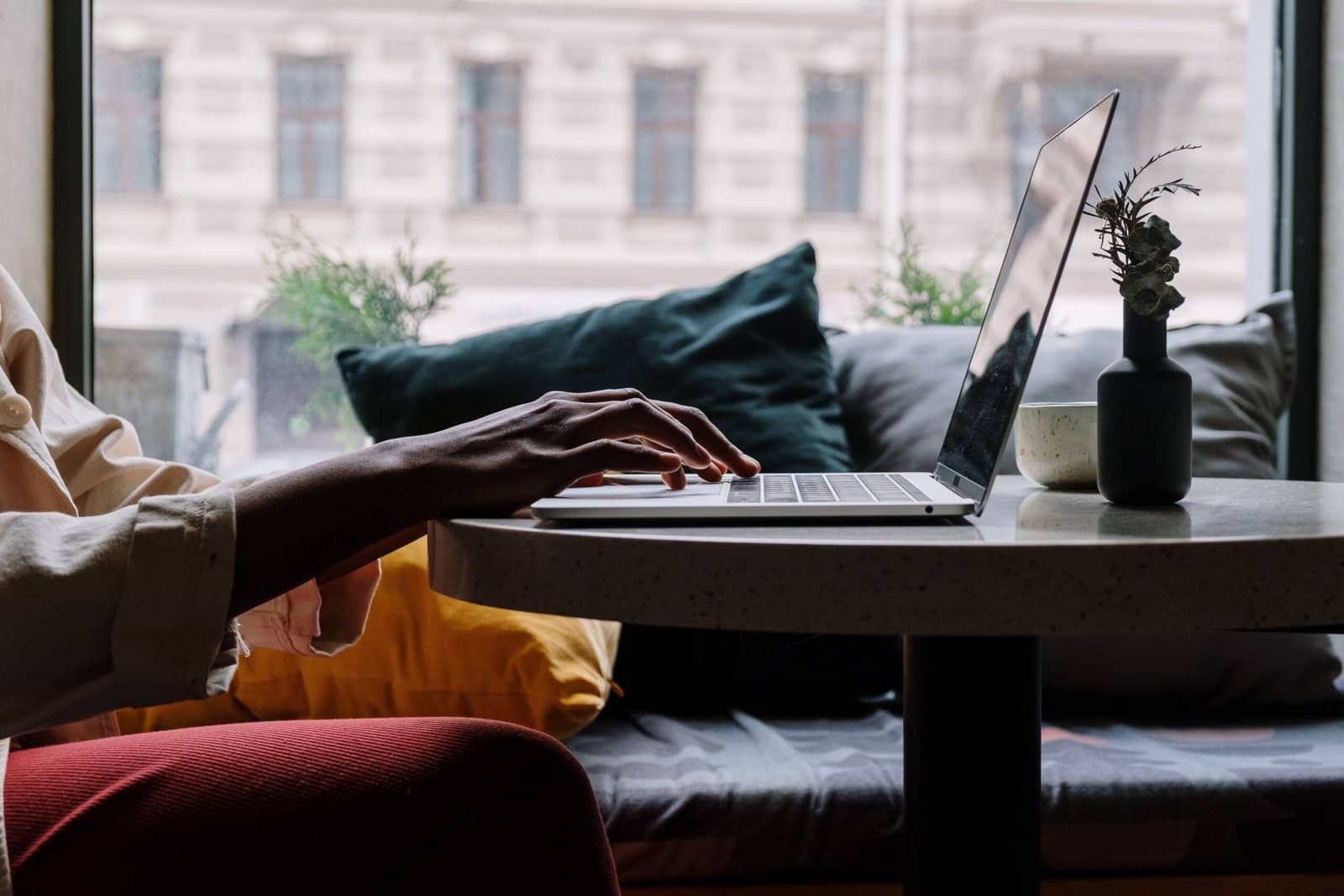 Image of person typing on a laptop