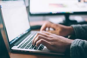 Image of Person Typing on Laptop Computer