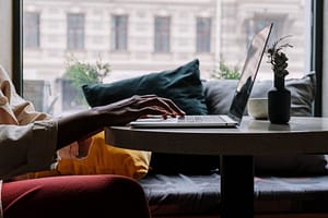 Image of person typing on a laptop